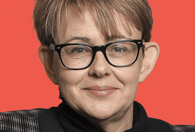head shot of woman with brown hair wearing glasses